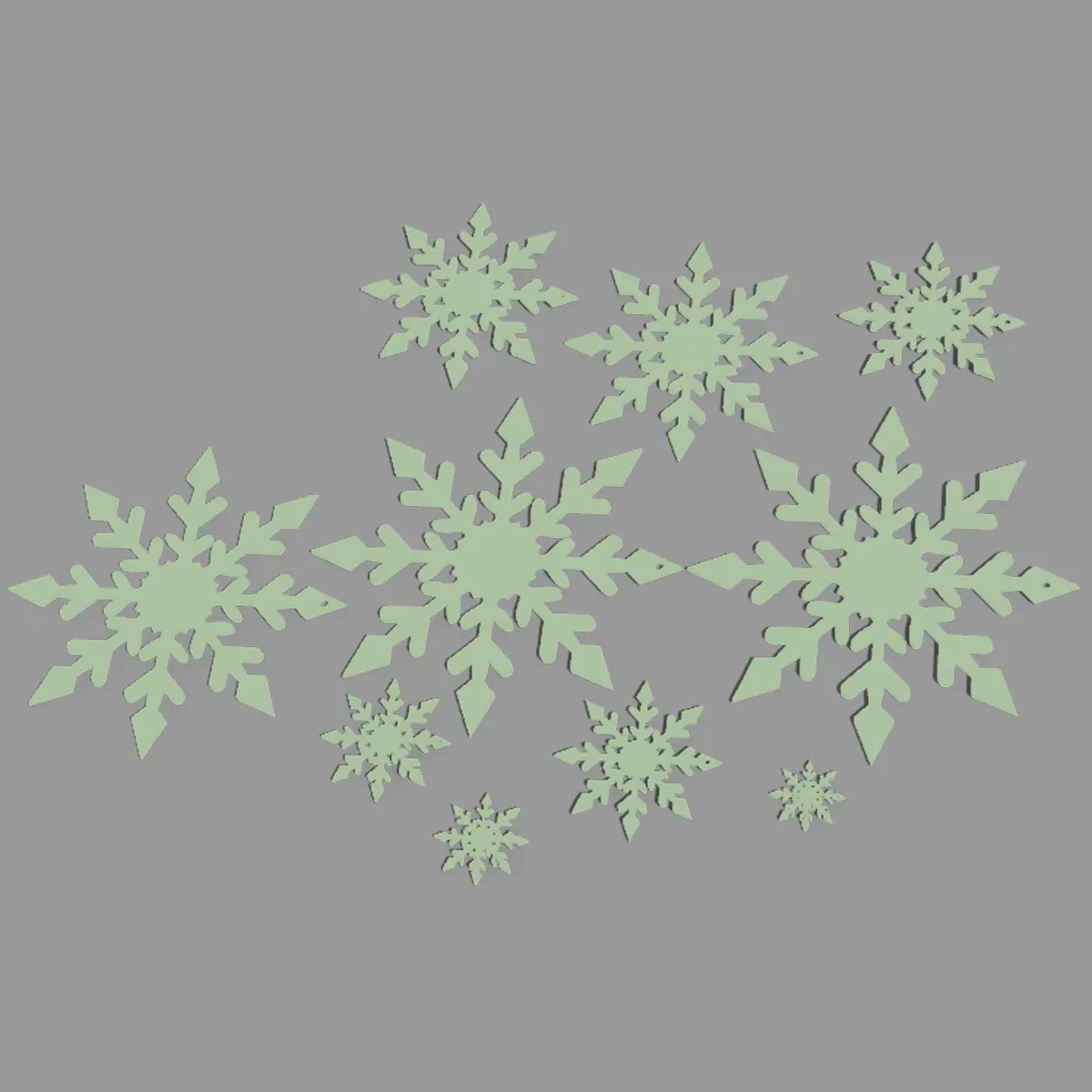 Green snowflakes in various sizes and fractal designs, decoratively arranged on a black background – perfect for creative crafting and decoration ideas.